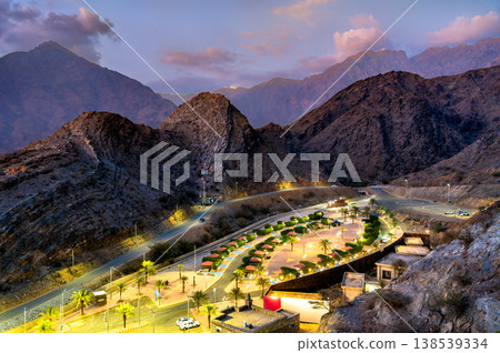High angle view of the illuminated Thee Ain Park surrounded by the Sarawat Mountains at twilight in Al Bahah, Saudi Arabia High angle view of the illuminated Thee Ain Park surrounded by the Sarawat Mountains at twilight in Al Bahah, Saudi Arabia 138539334