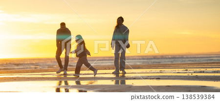 Family enjoying walking on beach at beautiful sunset 138539384