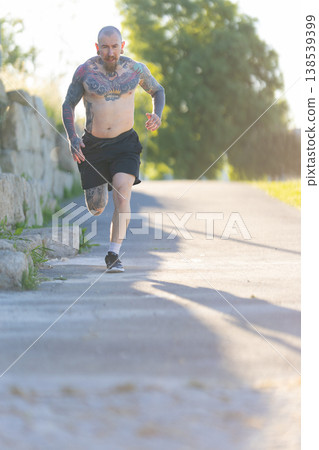 Tattooed man running outdoors for fitness training Tattooed man running outdoors for fitness training 138539399