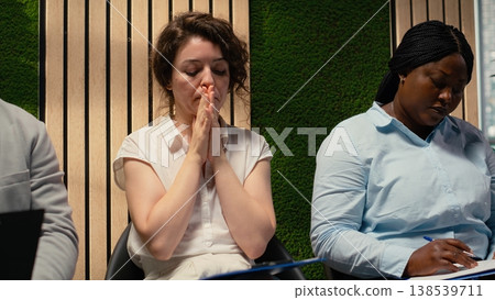 Scared impatient woman applicant getting extremely nervous and agitated while she waits in the queue outside HR office. Person sitting in line under pressure, deals with anxiety. Scared impatient woman applicant getting extremely nervous and agitated while she waits in the queue outside HR office. Person sitting in line under pressure, deals with anxiety. 138539711