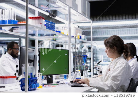 Green screen PC software used by lab scientist evaluating genetic markers associated with disease risk. Woman studies DNA strand mapping with genomics analysis program on chroma key computer Green screen PC software used by lab scientist evaluating genetic markers associated with disease risk. Woman studies DNA strand mapping with genomics analysis program on chroma key computer 138539789