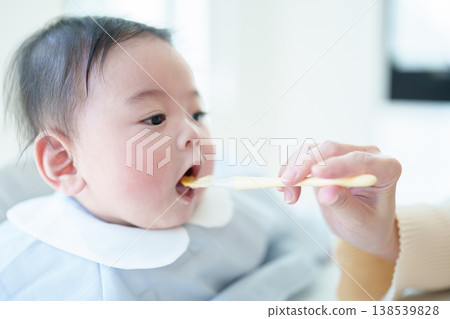 Baby eating baby food Baby eating baby food 138539828