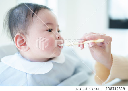 Baby eating baby food Baby eating baby food 138539829
