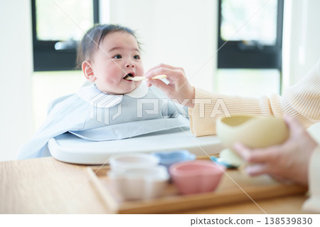 Baby eating baby food Baby eating baby food 138539830