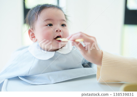 Baby eating baby food Baby eating baby food 138539831