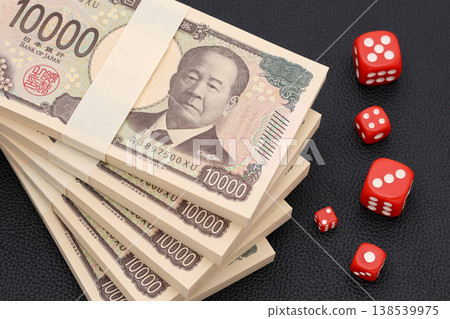 A stack of 10,000 yen bills and dice A stack of 10,000 yen bills and dice 138539975