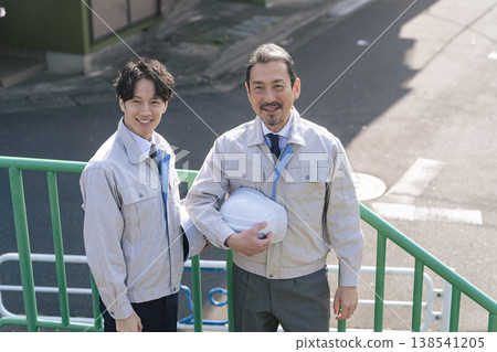 A group of male workers standing outdoors 138541205