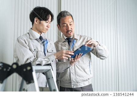 A group of male workers having a meeting. A group of male workers having a meeting. 138541244