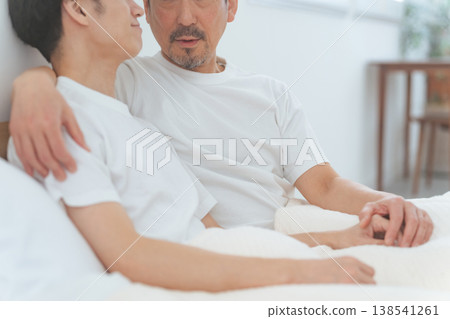 Two men cuddling in bed; homosexuality; LGBT Two men cuddling in bed; homosexuality; LGBT 138541261