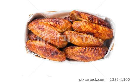 Grilled chicken wings in a paper container isolated on white background, top view. bbq chicken wings in disposable tray isolated, top view. Grilled chicken wings in a paper container isolated on white background, top view. bbq chicken wings in disposable tray isolated, top view. 138541300