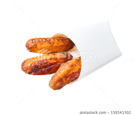 bbq chicken wings in a paper box isolated on white background, top view. 138541302