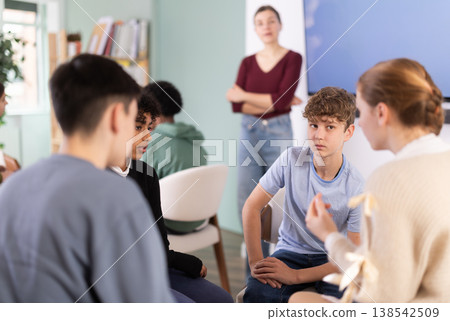 Teenage students working in two separate teams during lesson 138542509