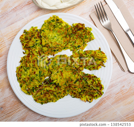 Fried zucchini fritters 138542553