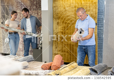 Elderly male buyer chooses soft carpet to create coziness in her apartment 138542595