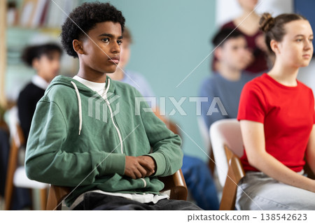 African American teen boy attendee group class and listen to lecturer. African American teen boy attendee group class and listen to lecturer. 138542623