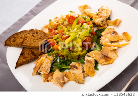 Salad from avocado, tomatoes and greens with trout Salad from avocado, tomatoes and greens with trout 138542628