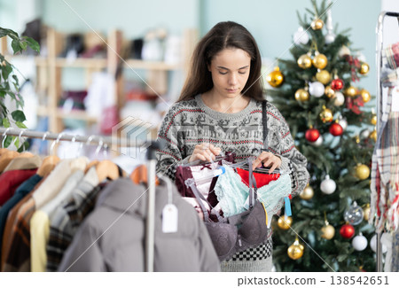 Young woman chooses lingerie in clothing store Young woman chooses lingerie in clothing store 138542651