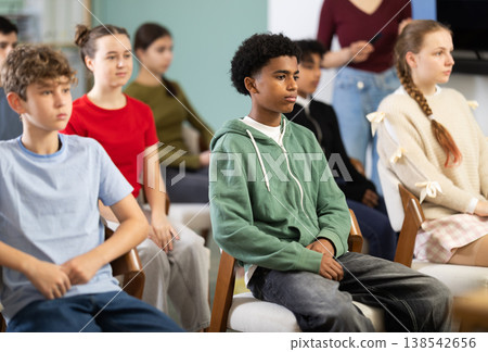 Teenage children sit in the classroom and look at the presentation Teenage children sit in the classroom and look at the presentation 138542656
