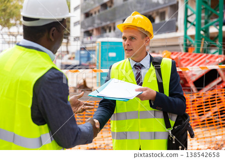 Builers shaking hands after signing documents Builers shaking hands after signing documents 138542658