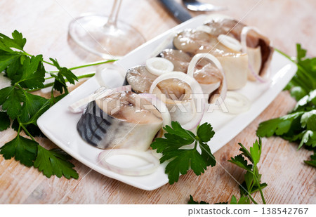 Sliced lightly salted mackerel fish served with onion and greens Sliced lightly salted mackerel fish served with onion and greens 138542767