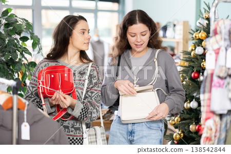 Two girls at trading floor pick out handbag, X mas shopping 138542844