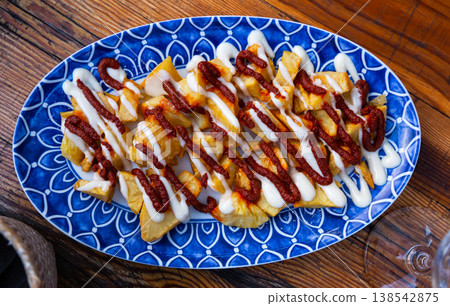 Baked in oven spanish tapas potatoes bravas baked with tomato sauce 138542875