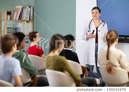 During talk in at class, teen pupil listen to doctor lecturer During talk in at class, teen pupil listen to doctor lecturer 138542876