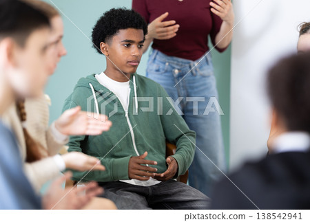 Teenage boy participating in group communication Teenage boy participating in group communication 138542941