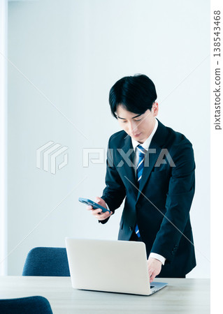 A young businessman calling in the office 138543468