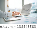 A woman working on a laptop and visualizing data analysis. An image of remote work and business growth. 138543583