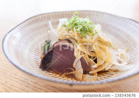 Japanese cuisine featuring fragrant seared bonito cooked over straw and plenty of condiments. Japanese cuisine featuring fragrant seared bonito cooked over straw and plenty of condiments. 138543676