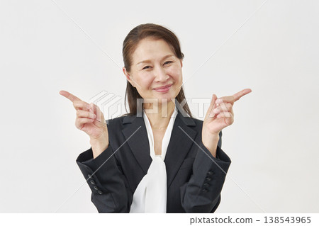 A woman pointing left and right on a white background 138543965