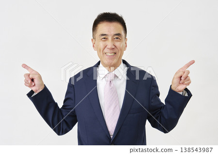 A businessman pointing left and right against a white background. A businessman pointing left and right against a white background. 138543987