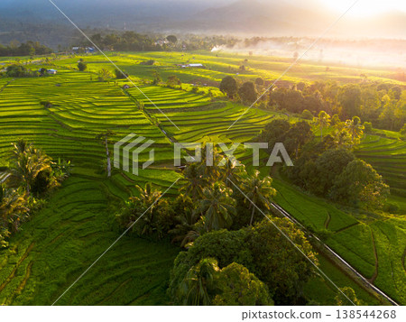 Beautiful morning view in Indonesia, panoramic landscape of rice fields with mountain ranges and clear sky 138544268