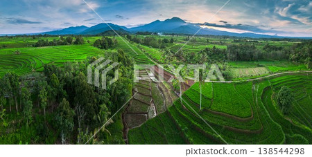 Beautiful morning view in Indonesia, panoramic landscape of rice fields with mountain ranges and clear sky Beautiful morning view in Indonesia, panoramic landscape of rice fields with mountain ranges and clear sky 138544298