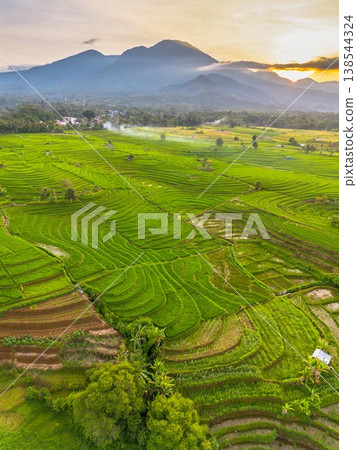 Beautiful morning view in Indonesia, panoramic landscape of rice fields with mountain ranges and clear sky Beautiful morning view in Indonesia, panoramic landscape of rice fields with mountain ranges and clear sky 138544324