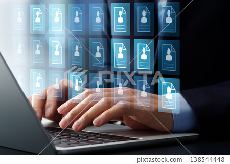 Applicant management systems and technology. Applicant tracking and hiring process automation software. Candidates on laptops. 138544448