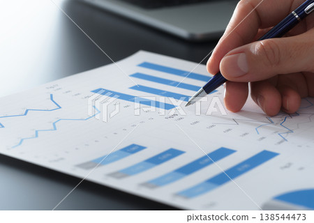 Business reports and financial data analysis. Documents with graphs and charts. Reviewing plans and making decisions at your desk. 138544473