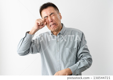 A senior man in casual clothes standing – a lifestyle image. A senior man in casual clothes standing – a lifestyle image. 138544721