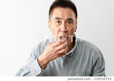 A senior man in casual clothes standing – a lifestyle image. A senior man in casual clothes standing – a lifestyle image. 138544729