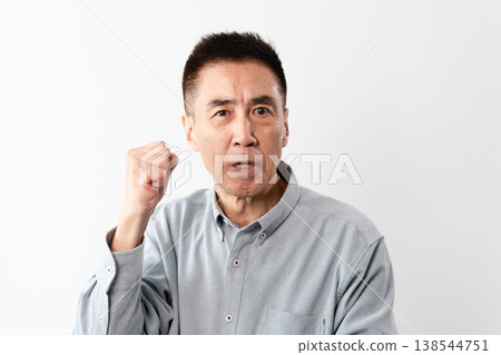A senior man in casual clothes standing – a lifestyle image. A senior man in casual clothes standing – a lifestyle image. 138544751