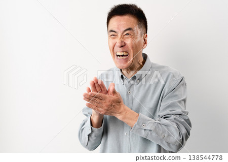 A senior man in casual clothes standing – a lifestyle image. A senior man in casual clothes standing – a lifestyle image. 138544778
