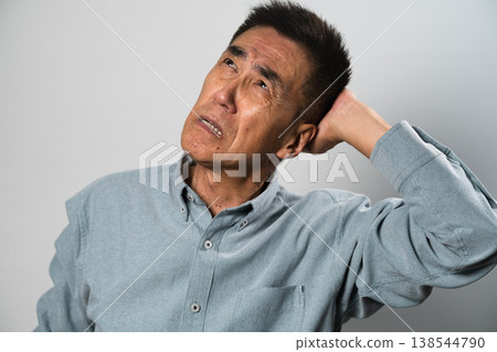A senior man in casual clothes standing – a lifestyle image. A senior man in casual clothes standing – a lifestyle image. 138544790