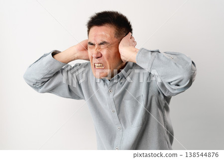A senior man in casual clothes standing – a lifestyle image. A senior man in casual clothes standing – a lifestyle image. 138544876