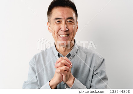 A senior man in casual clothes standing – a lifestyle image. A senior man in casual clothes standing – a lifestyle image. 138544898