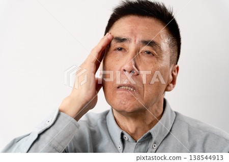 A senior man in casual clothes standing – a lifestyle image. A senior man in casual clothes standing – a lifestyle image. 138544913