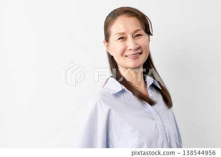 A senior woman in casual clothes standing – a lifestyle image. A senior woman in casual clothes standing – a lifestyle image. 138544956