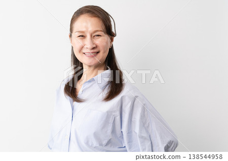 A senior woman in casual clothes standing – a lifestyle image. 138544958