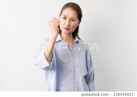 A senior woman in casual clothes standing – a lifestyle image. A senior woman in casual clothes standing – a lifestyle image. 138545021