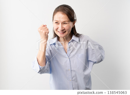 A senior woman in casual clothes standing – a lifestyle image. A senior woman in casual clothes standing – a lifestyle image. 138545063